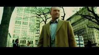 bald man in beige coat in city park — Limitless