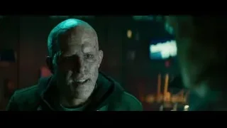 bald man in hoodie in dark cityscape — Deadpool 2