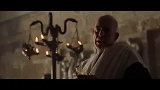 Bald man in white robe with wine and candelabra — Gladiator