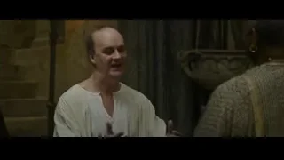 Bald man smiling in stone room — Gladiator 2