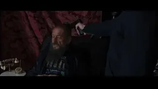 bearded man in chair with gun — Iron Man 3