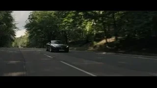 black sports car driving in woods — F1