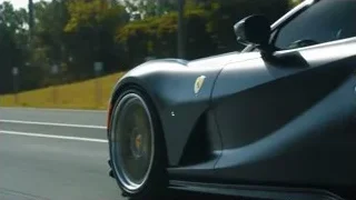 black sports car driving on road — Sports Cars