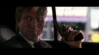 Bloody faced man holding gun in car — Batman: The Dark Knight