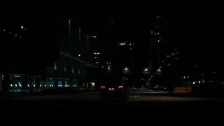 City street at night with lit buildings — Batman: The Dark Knight Rises