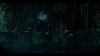 dinosaurs in dark forest with laser beams — Jurassic World