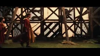 Four young men in red robes with brooms — Harry Potter and the Philosophers Stone