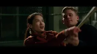 girl holding baseball bat at chain-link fence — Bruce Lee: Birth of The Dragon