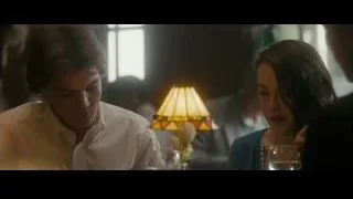 group of people around table in dim room — Into the Wild