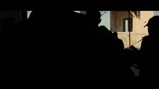 group of people silhouetted by window — Batman: The Dark Knight Rises