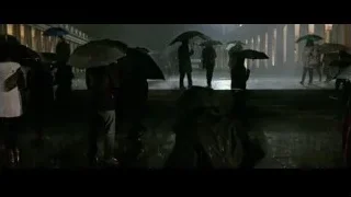 group of people with umbrellas in heavy rain — Now You See Me 2