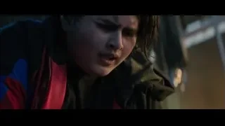 hands holding small black object outdoors — Deadpool 2