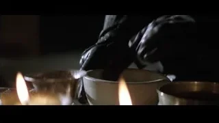 Hands in black gloves holding white bowl — Batman