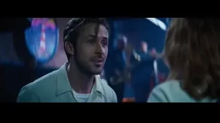 Man and woman in dimly lit room — La La Land