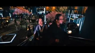 Man and woman in kimonos on escalator — John Wick: Chapter 4