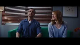 man and woman sitting on green couch — La La Land