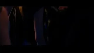 man and woman talking in dimly lit room — Limitless