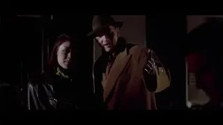 Man and woman talking in dimly lit room — American Psycho
