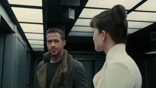 Man and woman talking in hallway — Blade Runner 2049