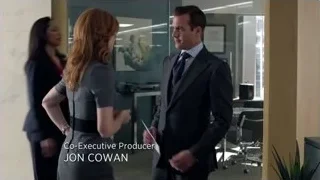 man and woman talking in office lobby — Suits