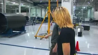Man and woman walking towards large machine — Elon Musk: Return to Space