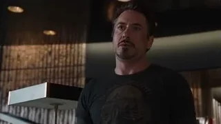 man holding whiskey in dimly lit room — The Avengers