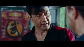 man in black and red jacket smiling — The Karate Kid