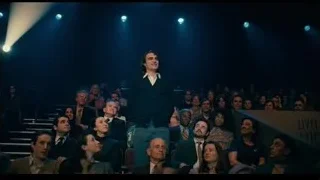 Man in black suit giving speech to crowd — Joker