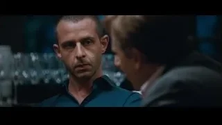 man in blue shirt in dimly lit room — The Big Short