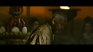 man in gold robe in dimly lit room — Gladiator 2
