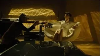 man in helmet and woman on armchair — Blade Runner 2049