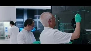 man in lab coat looking at futuristic screen — Now You See Me 2
