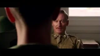 man in military uniform sitting serious expression — Hacksaw Ridge