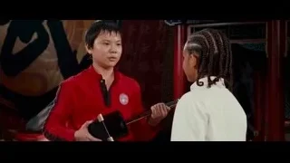 man in red jacket in Chinese setting — The Karate Kid