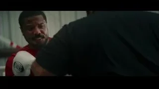 Man in red shirt sparring in gym — Creed 3