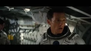 man in space suit standing in futuristic room — Interstellar