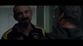 Man in striped shirt smiling in hallway — Creed