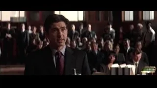 man in suit addressing large group — Batman