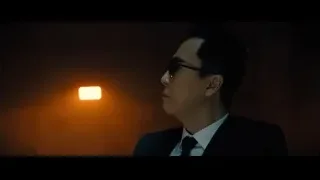 man in suit and sunglasses in dim light — John Wick: Chapter 4