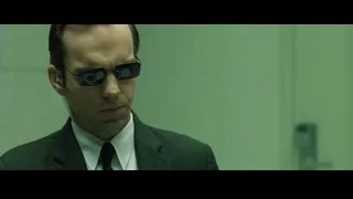 man in suit and sunglasses in green room — The Matrix