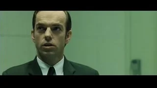 man in suit and tie against green wall — The Matrix