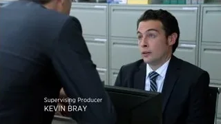 Man in suit at desk talking in office — Suits