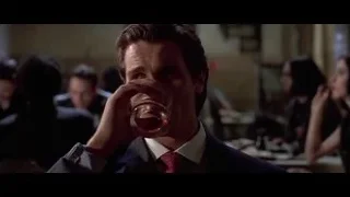 man in suit drinking whiskey — American Psycho