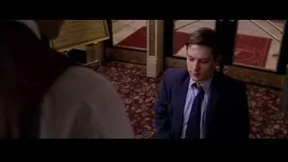 Man in suit holding paper and smiling — Spider Man 2