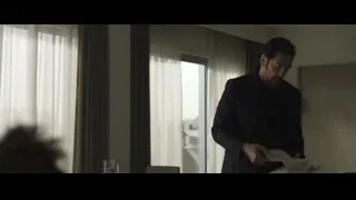 man in suit holding paper in room — F1