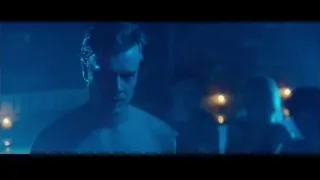 man in suit in dark room with blue light — John Wick