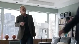 man in suit in living room with city view — Suits