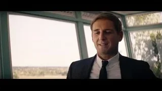 man in suit looking out large window — Ford v Ferrari