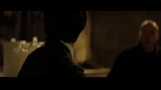 man in suit looking up in dim room — Batman