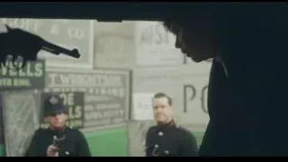 Man in suit pointing gun at police — Peaky Blinders